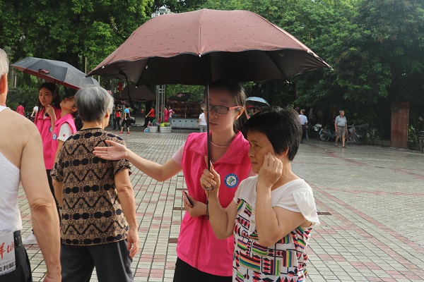 志愿者雨中为来诊的市民导诊