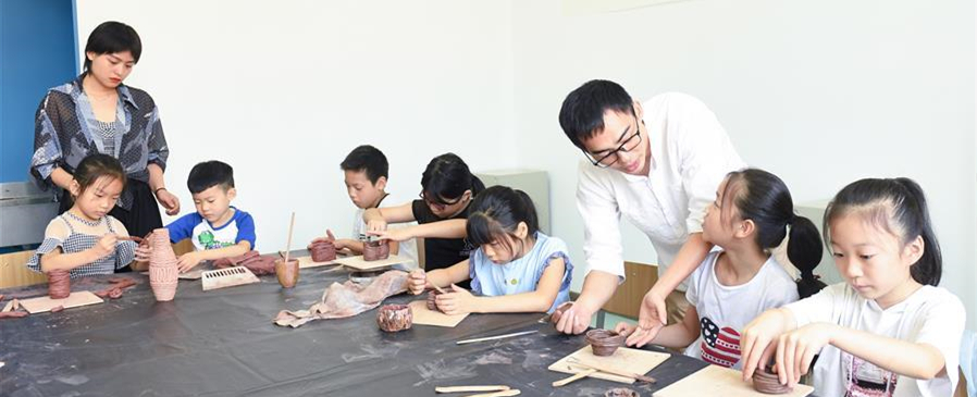        8月6日，大学老师志愿者在吴兴区青少年活动中心指导儿童进行陶艺制作。