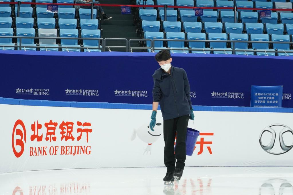 2021-2022赛季亚洲花样滑冰公开赛前，杨曦为赛前训练的运动员补冰。新华社发（樊康摄）